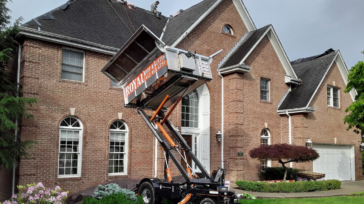 Royal Roof & Gutter material lift truck at a residential roofing job